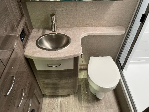 The toilet and sink in the Delano camper bathroom.