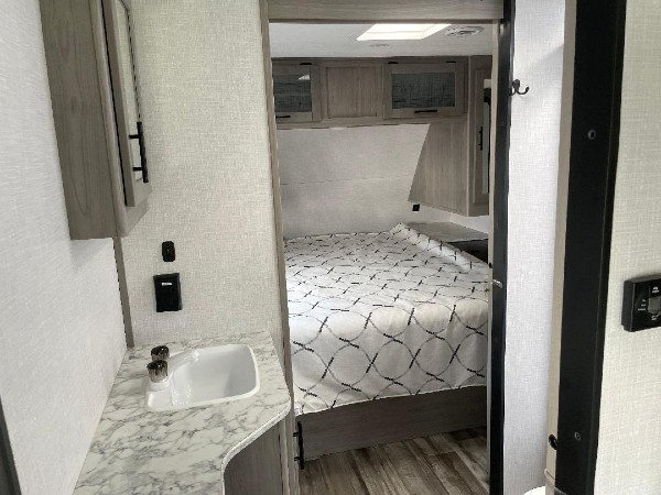 The bathroom right next to the master bedroom in a Dutchmen Coleman camper.