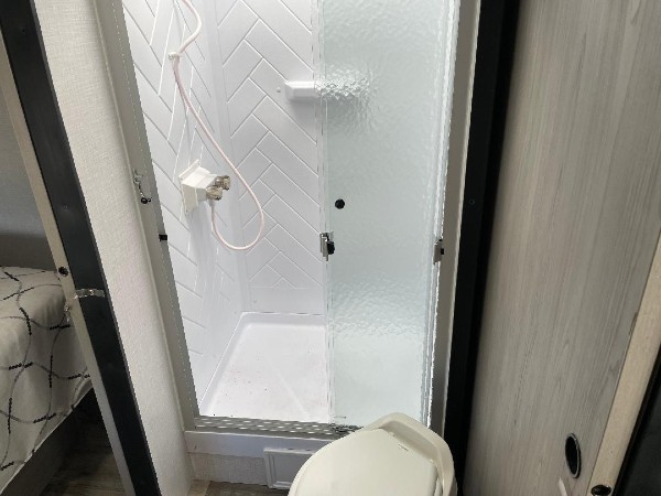 The shower inside of a Dutchmen Coleman Camper.