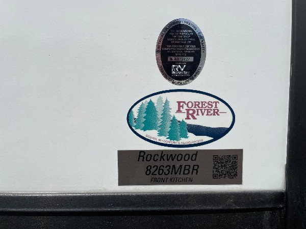 A Forest River sign on the side of a camper.