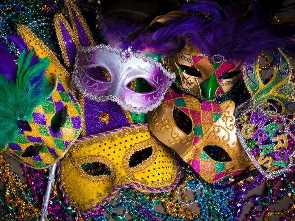 some mardi gras mask along with mardi gras beads
