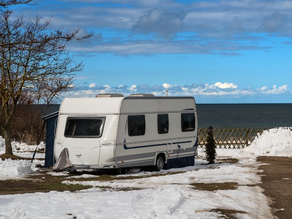 A camper being used in the winter by the lake