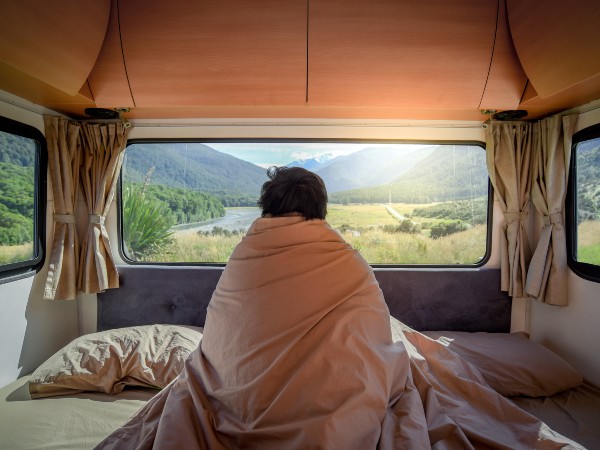 a man in a blanket while camping