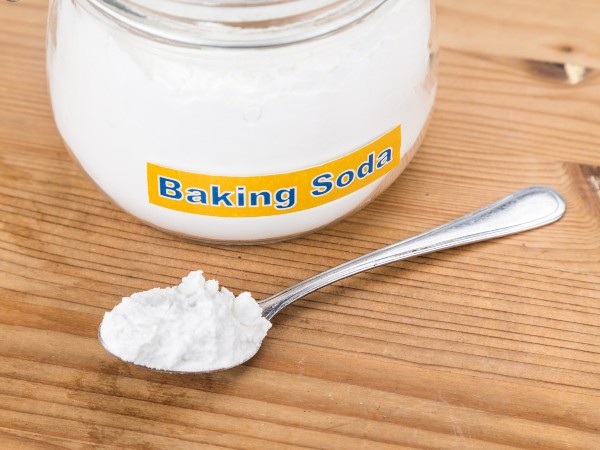 A can of baking soda with a spoon in front of it
