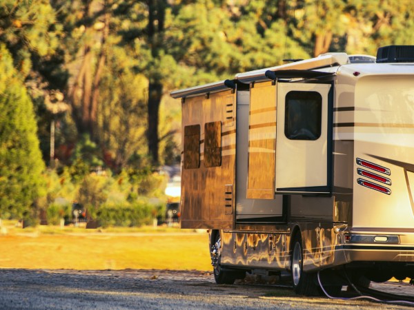 a parked motorhome with trees in the background