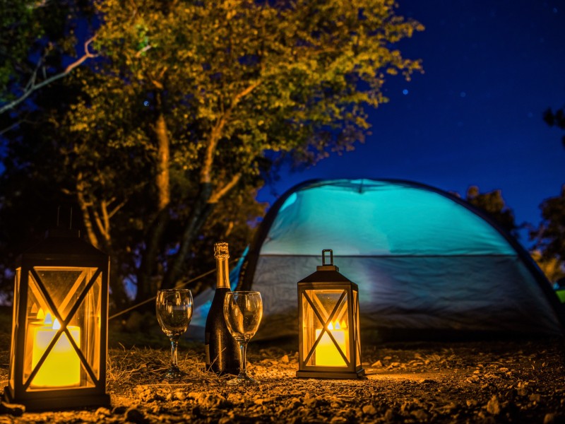 Two lanterns by a camping area