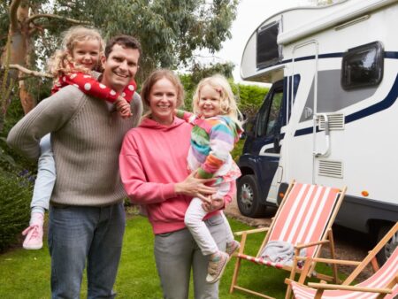 A family right next to their white camper