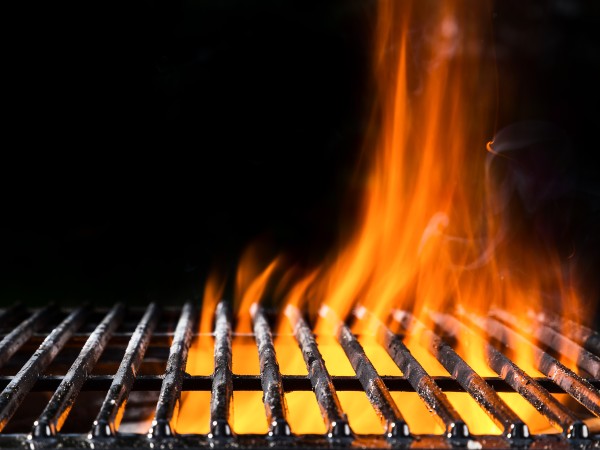 An empty grill with the fire going