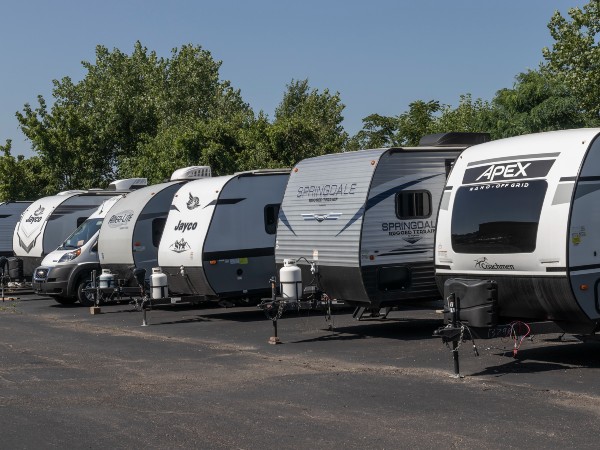 Some fifth wheel recreational vehicles lined up next to each other