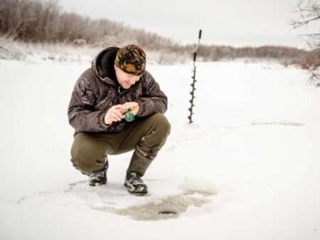 Man ice fishing, who will return to fish house RV momentarily