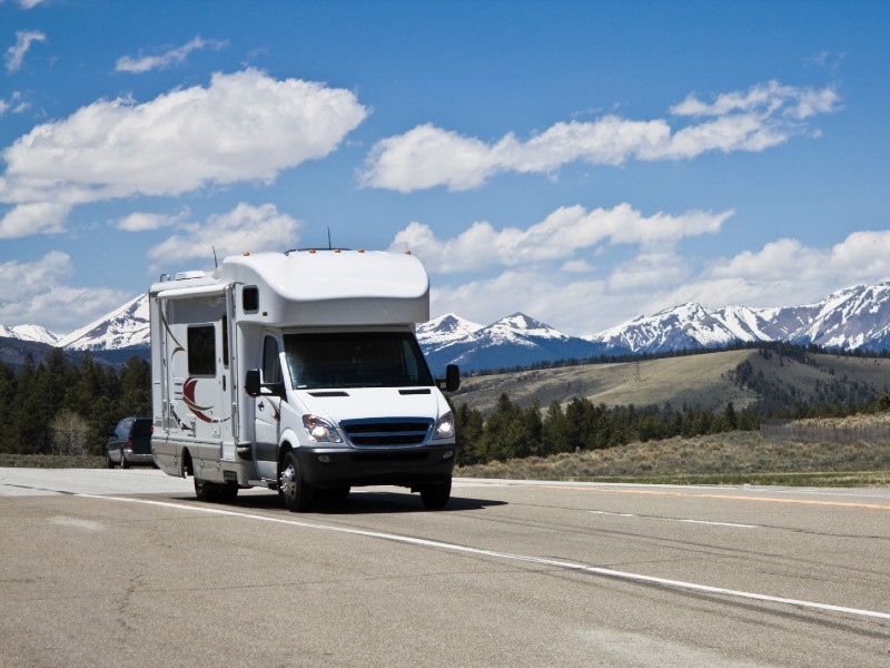 an RV driving on the road on a clear day