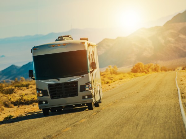 a motorhome on the road at sunrise