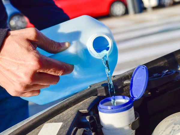 Motorhome wiper fluid being poured into the engine
