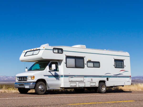 A white motorhome driving on the highway