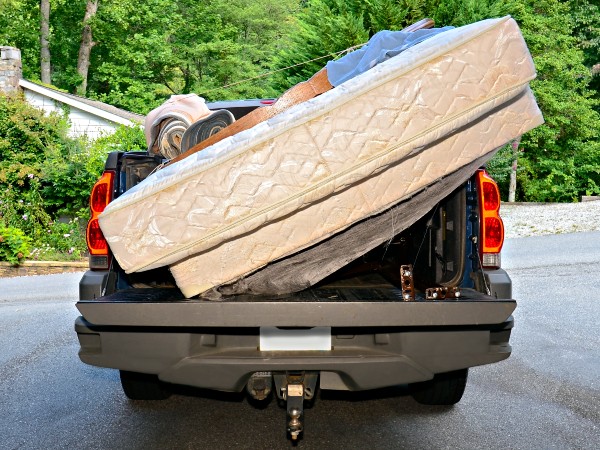 a short bed truck hauling two mattresses