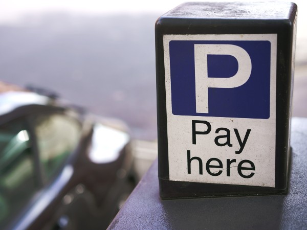 a sign representing where to pay for parking