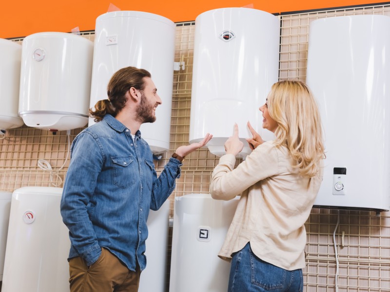 Two people looking at water heaters in a store