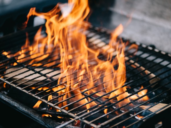 A wood burning grill with the fire going